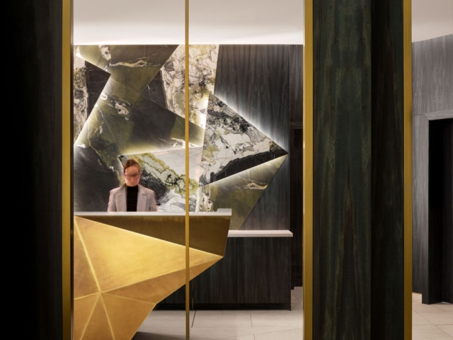 Arched mirror view of The Dorian front desk