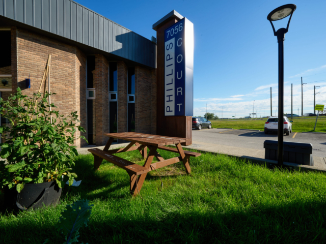 Picnic table beside Phillips Court sign