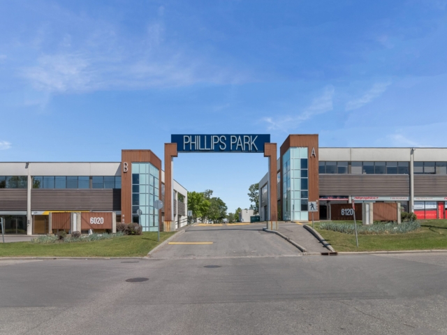 Phillips Park entrance between commercial buildings