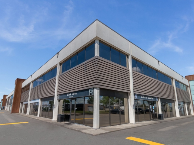 Corner retail building with glass storefronts